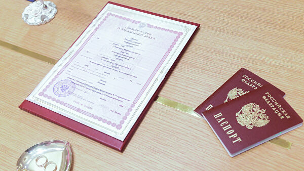 Кольца новобрачных, свидетельство о браке и паспорта молодоженов. Архивное фото